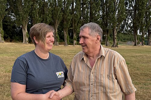 Liz Morgan-Danvers on the left, shaking hands with Gary Long on the right