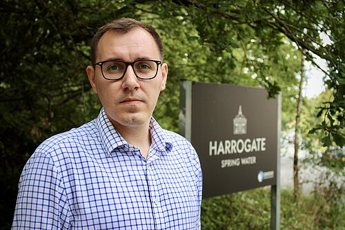 Tom Gordon MP stood by Harrogate Spring water sign