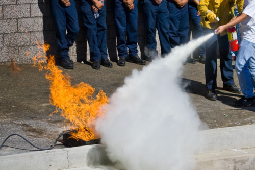 A fire being put out by an extinguisher