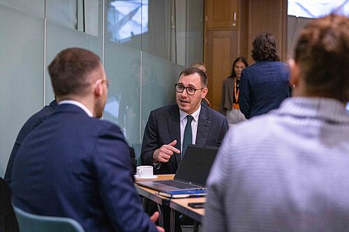 Tom pictured in a meeting.
