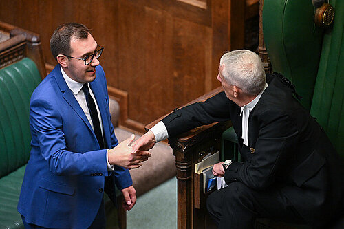 Tom shaking hands with speaker within commons