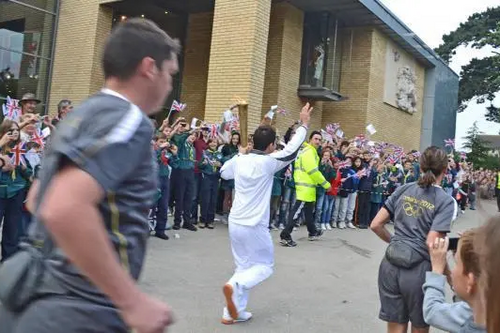 Olympic torch bearer in front of Chelmsford museum