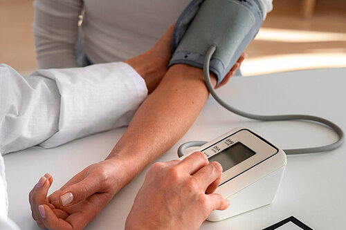 Photo of someone having their blood pressure tested