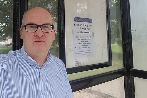 Michael Headley beside a disused bus stop