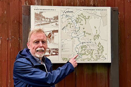 Photo of a man pointing at a map of the old Hereford to Gloucester railway line