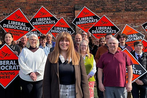 Group of Liberal Democrat campaigners in North East Lincolnshire holding “Winning Here” signs during local election 2026 campaign