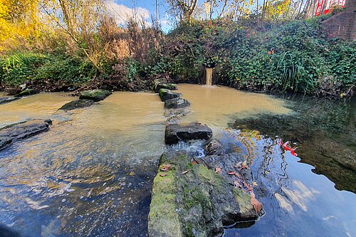 Sewage leaking into a river.