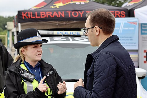 Tom Gordon stood speaking to a police officer