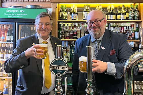 Image of two men behind a bar